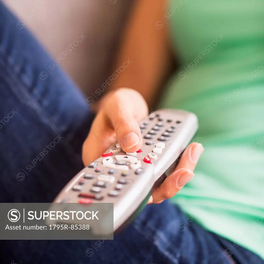 Close up of woman's hand holding remote control