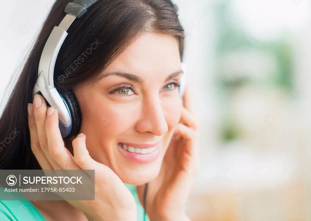 Portrait of woman listening to music on headphones