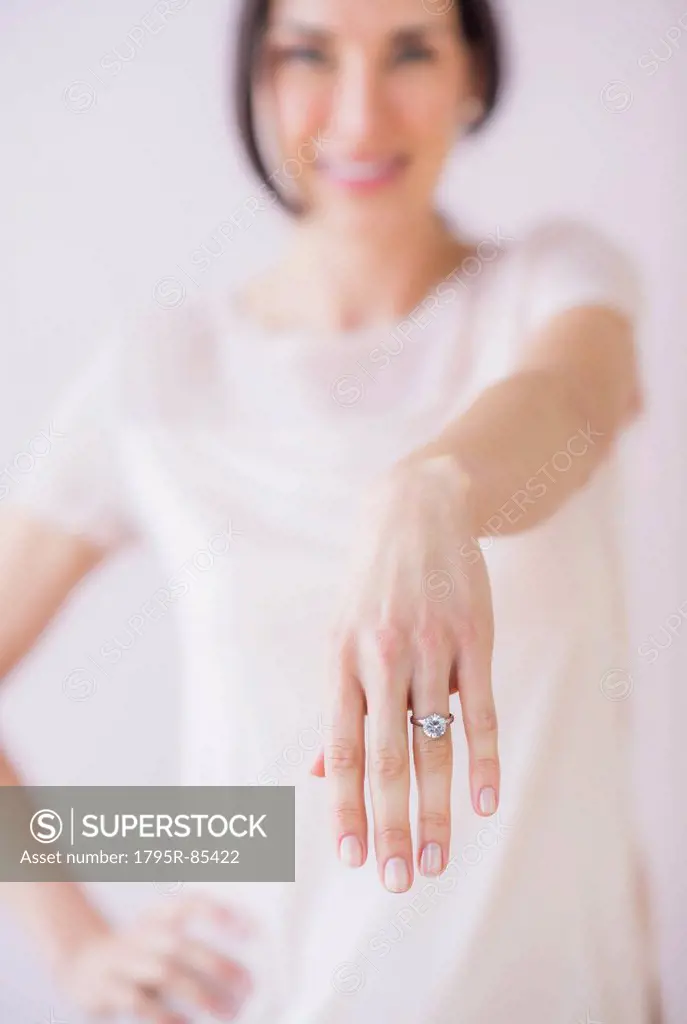 Studio Shot of woman showing her engagement ring