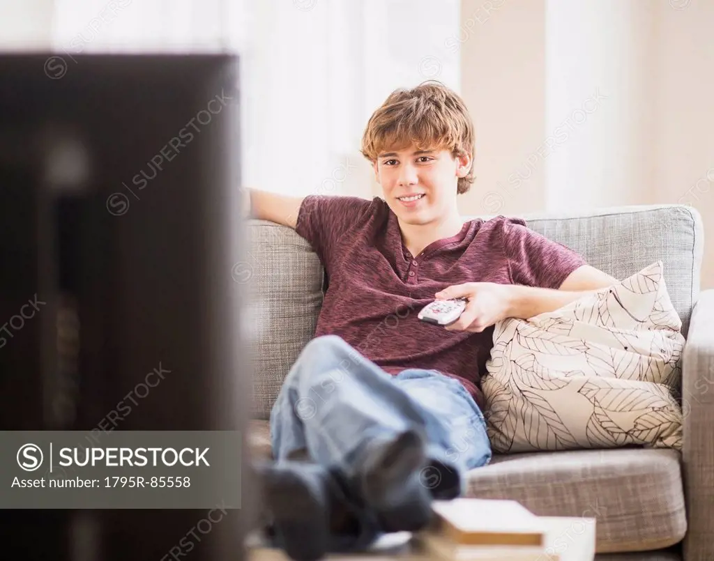 Teenage boy (14-15) watching tv