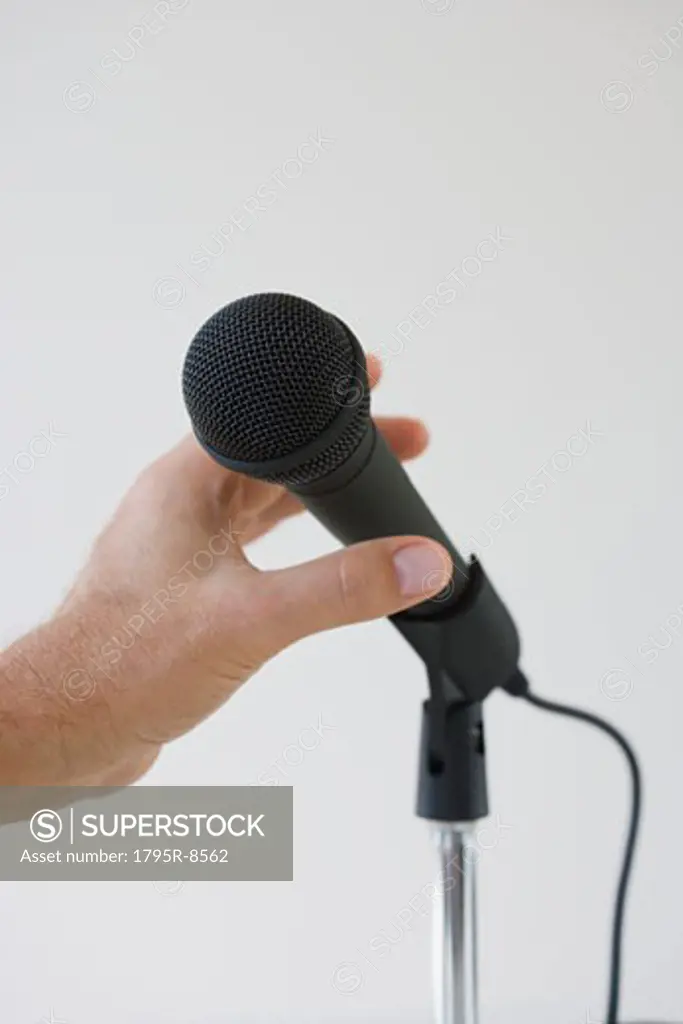Man reaching for microphone