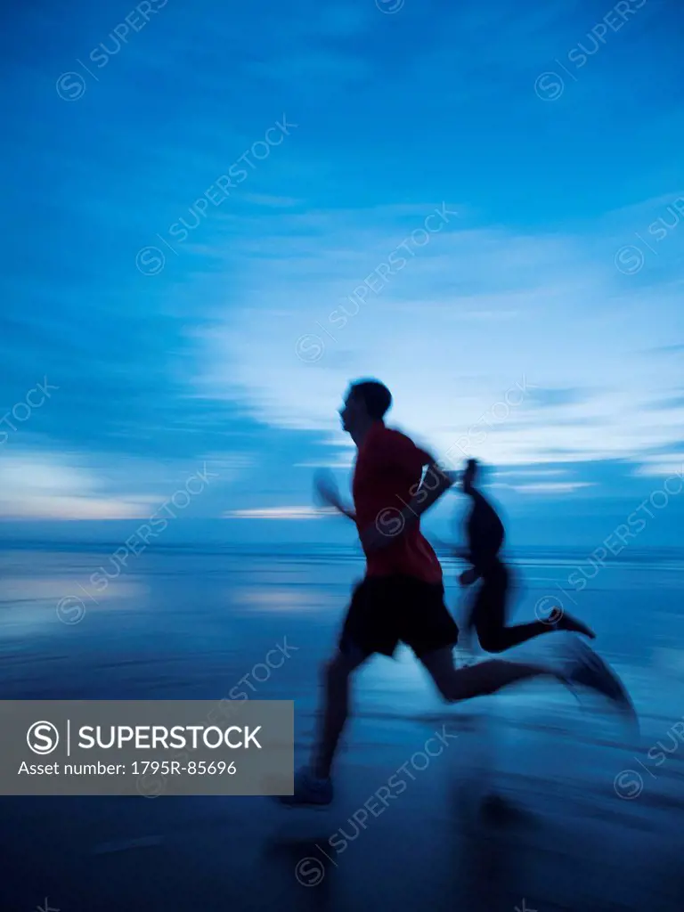 Man running along beach