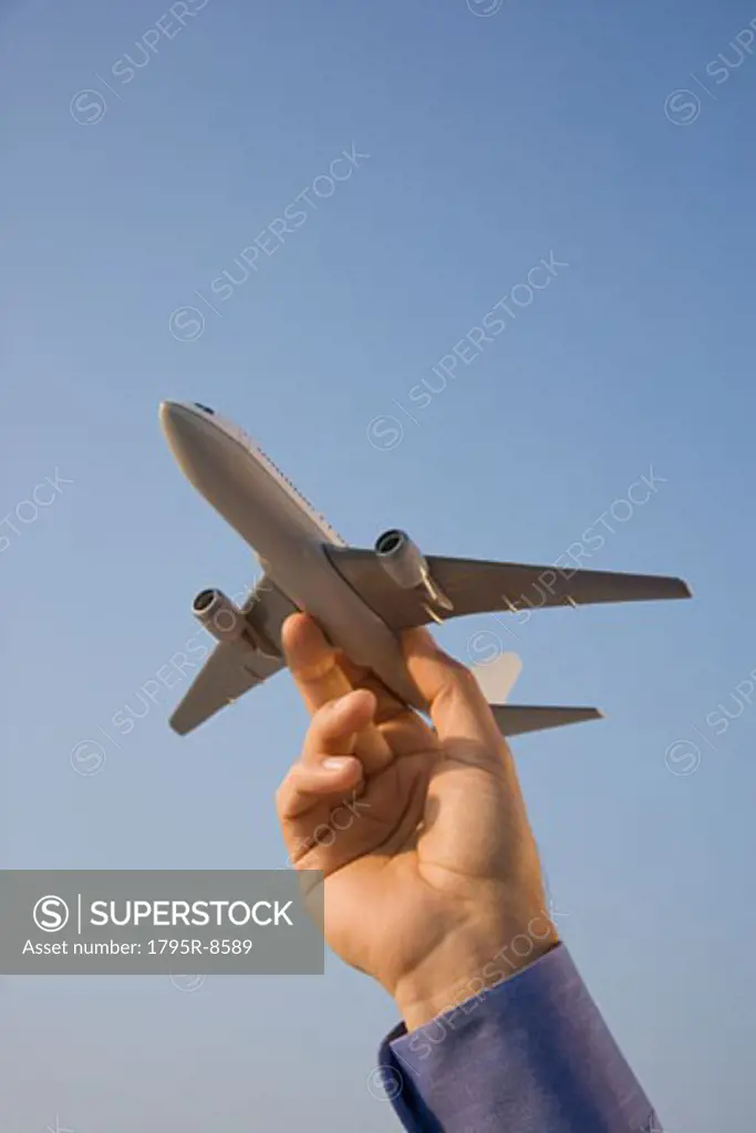 Man holding toy airplane