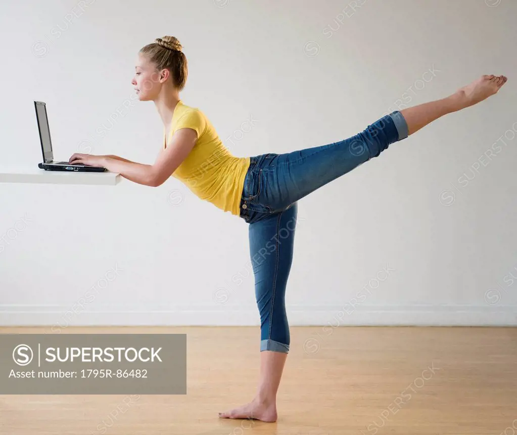 Portrait of teenage (16-17) ballerina using laptop