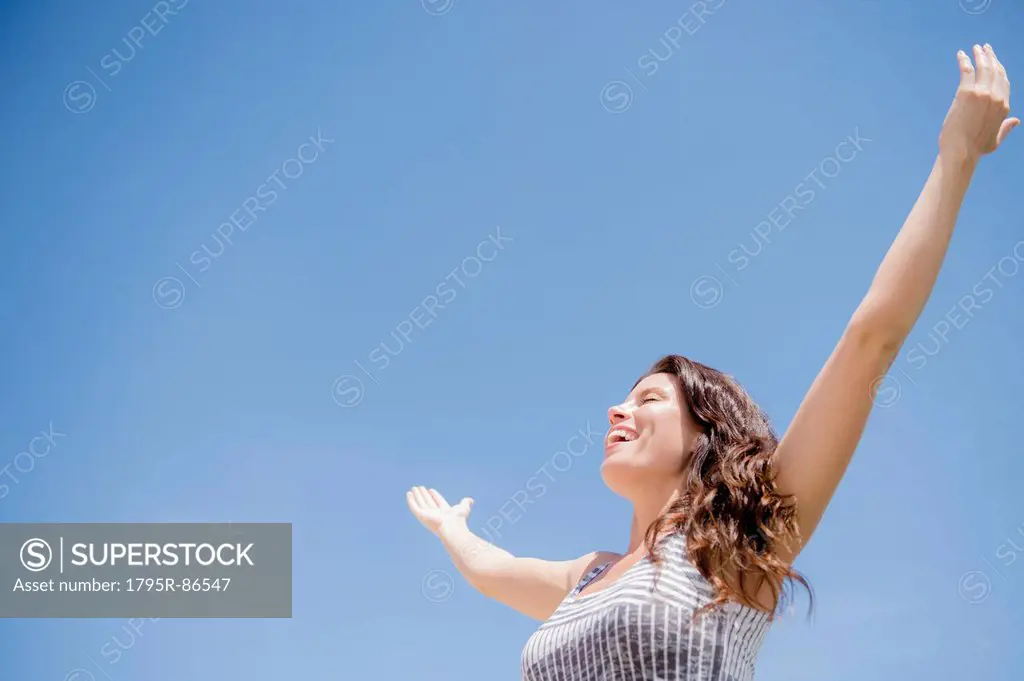 Happy woman against blue sky