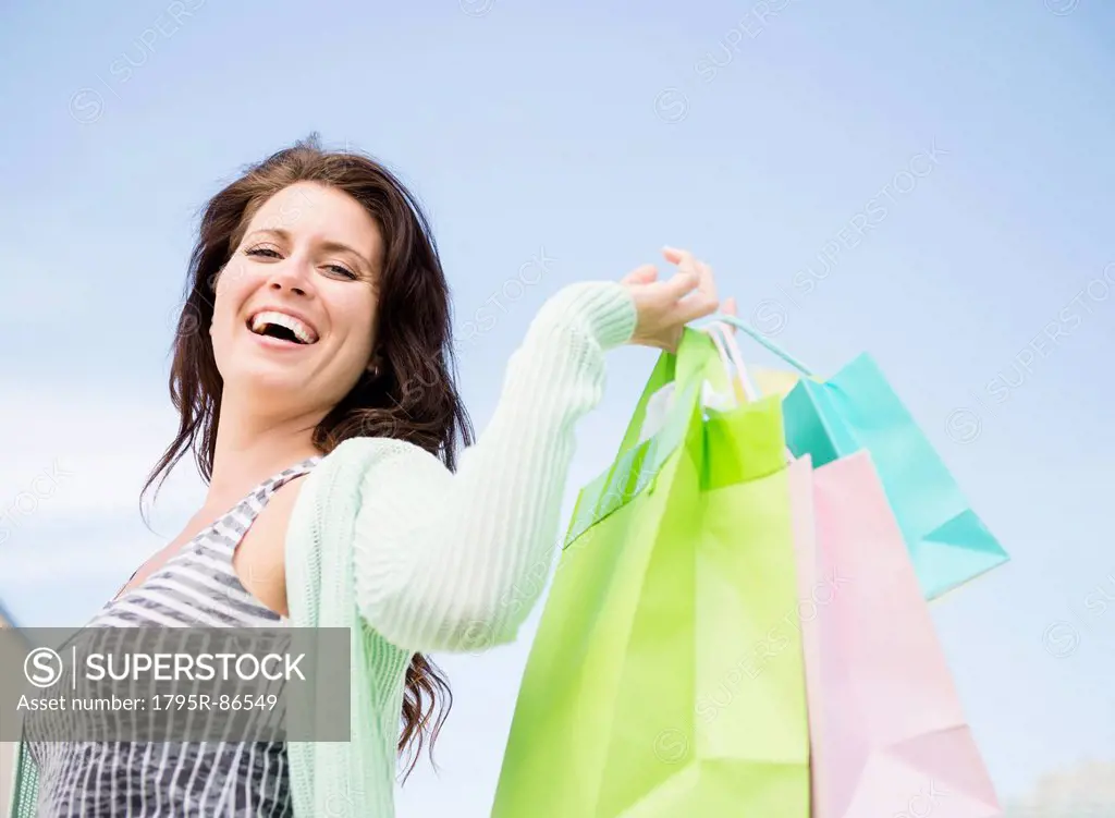 Happy woman holding shopping bags