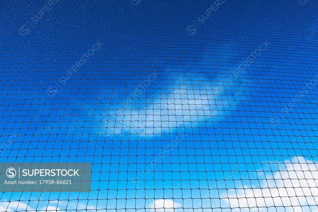 Grid-wire fence against sky