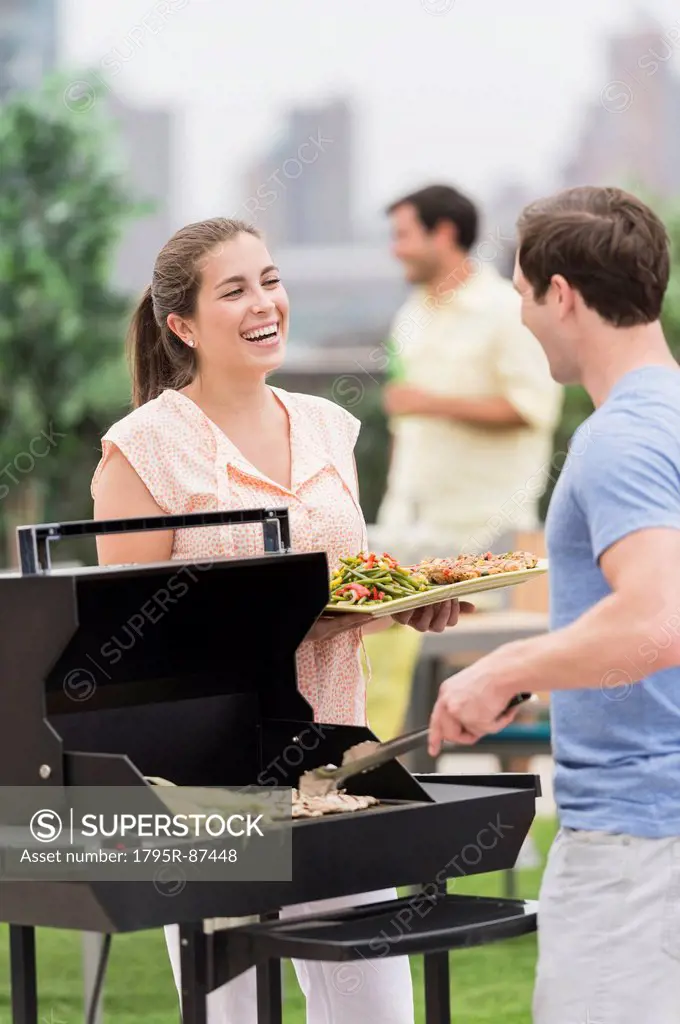 Friends enjoying barbecue in garden