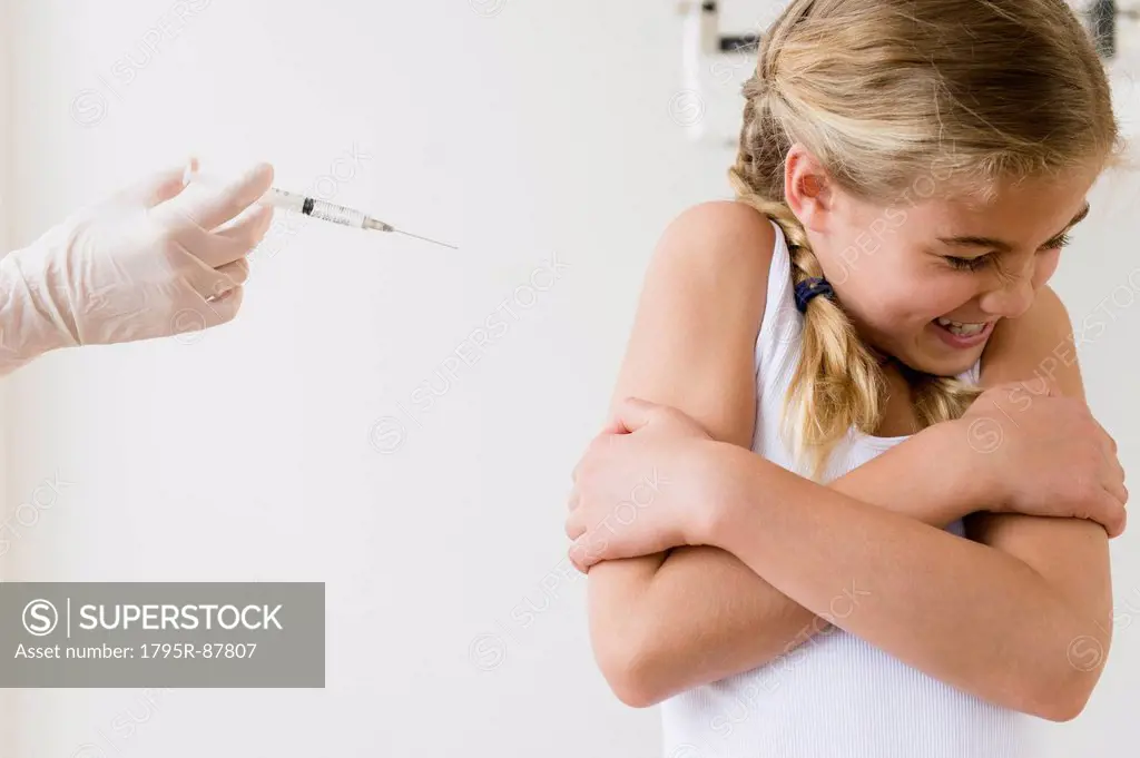 View of girl (8-9) scared of injection