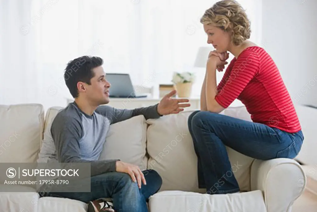 Couple talking on sofa