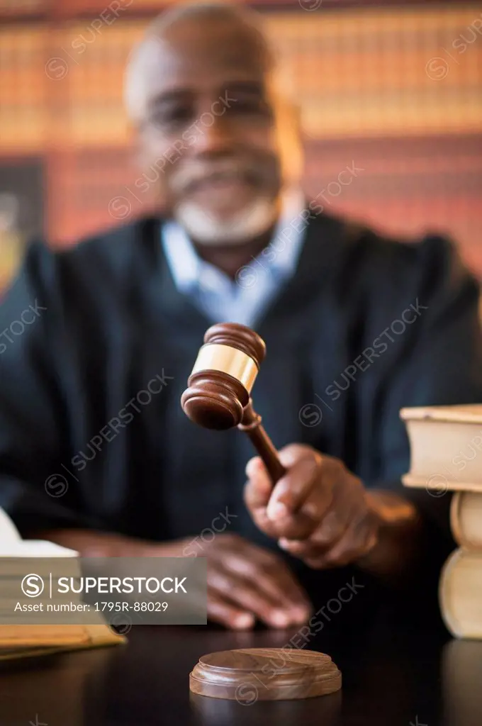 Judge holding gavel in courtroom