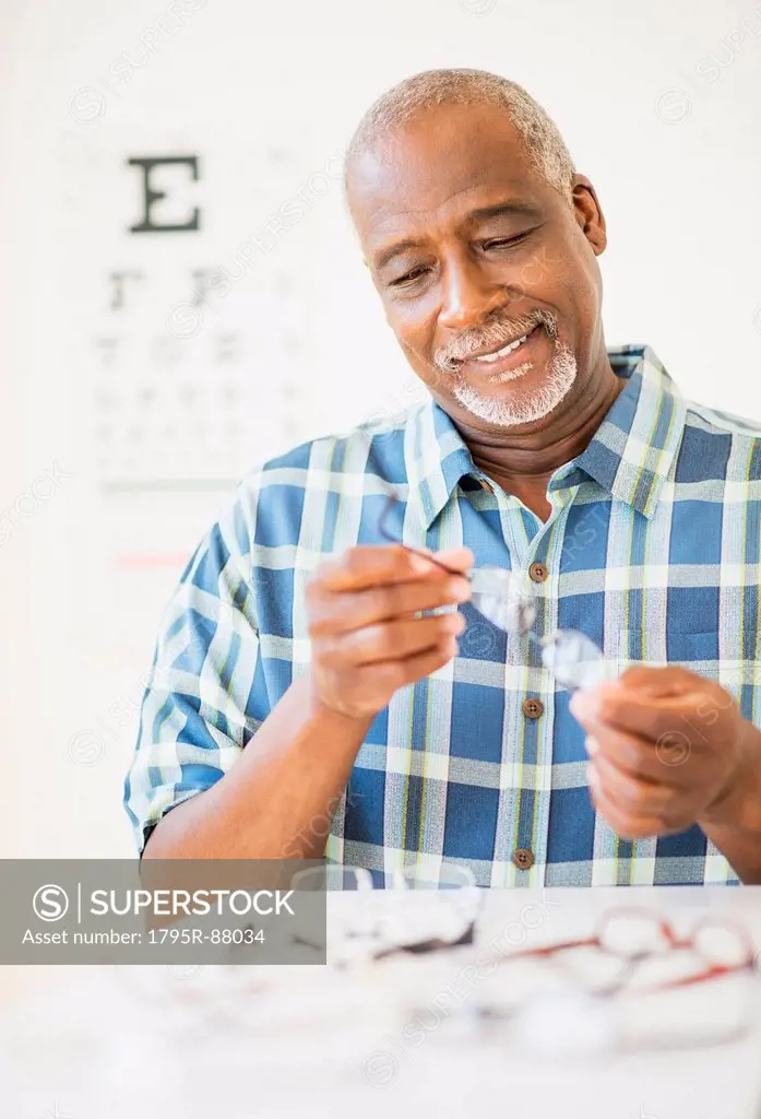 Man looking at glasses in store
