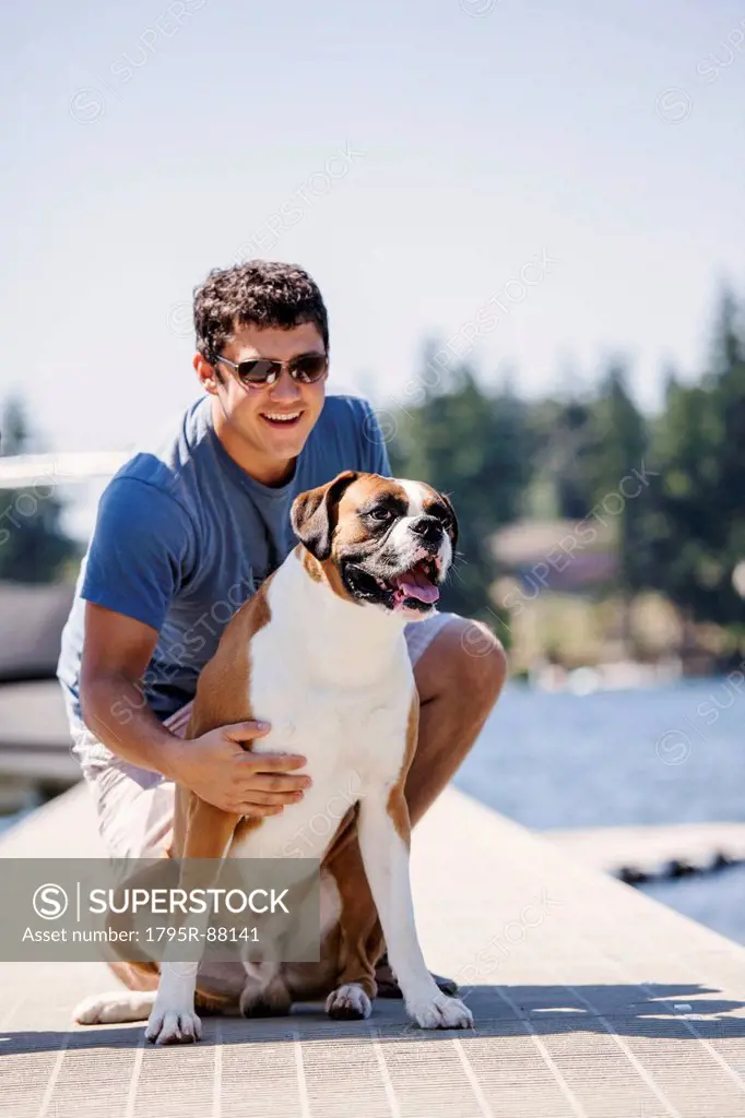 Portrait of young man posing with his dog