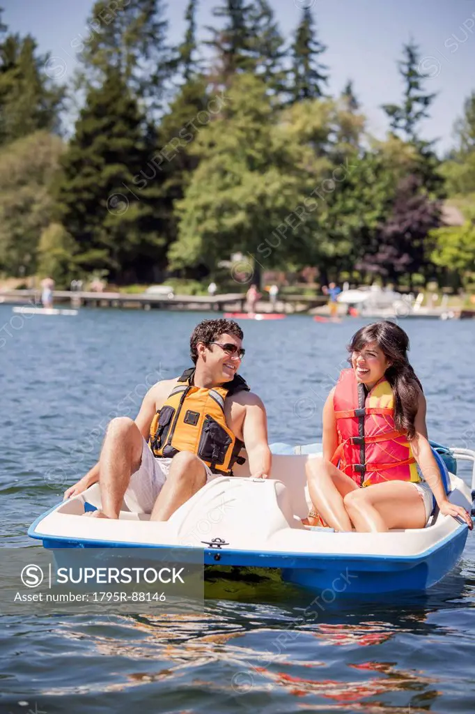 Young man and woman on paddle boat