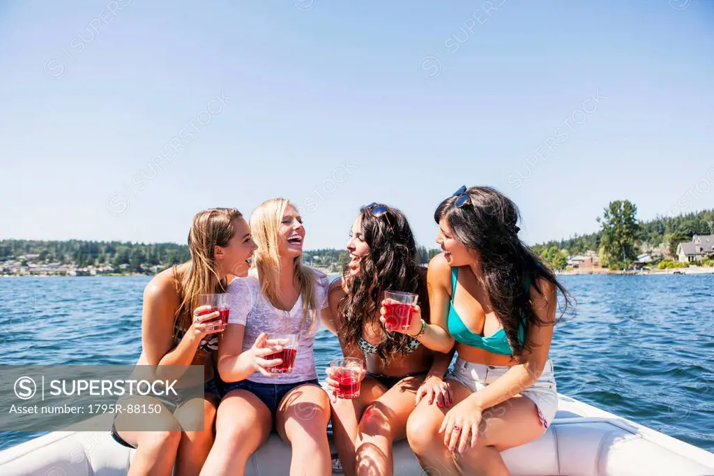 Young women having fun on motorboat