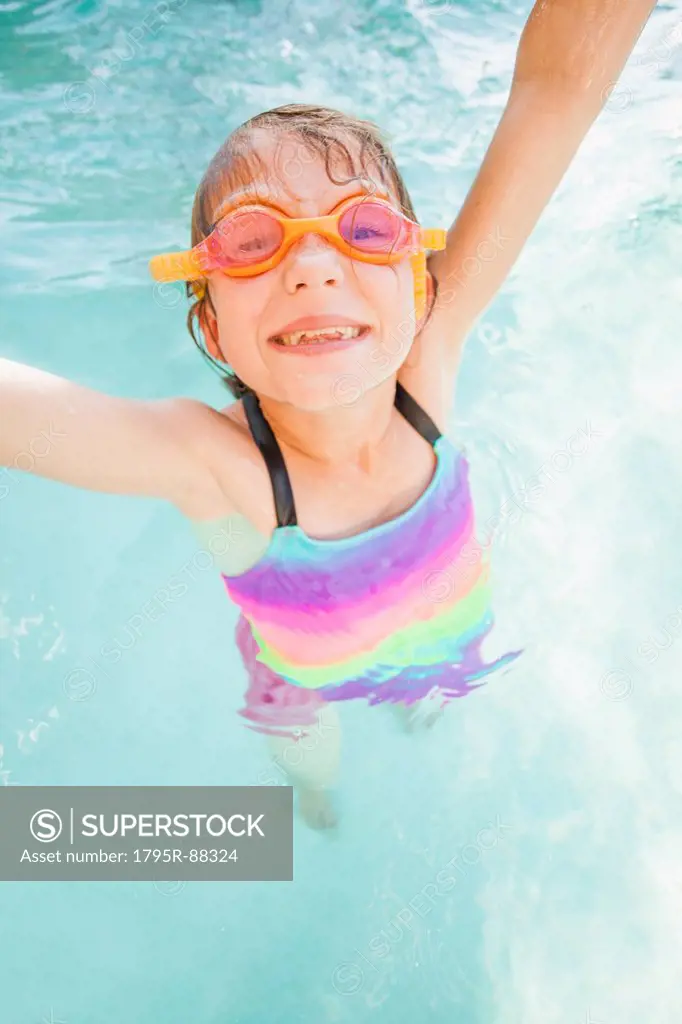 Girl (8-9) playing in swimming pool