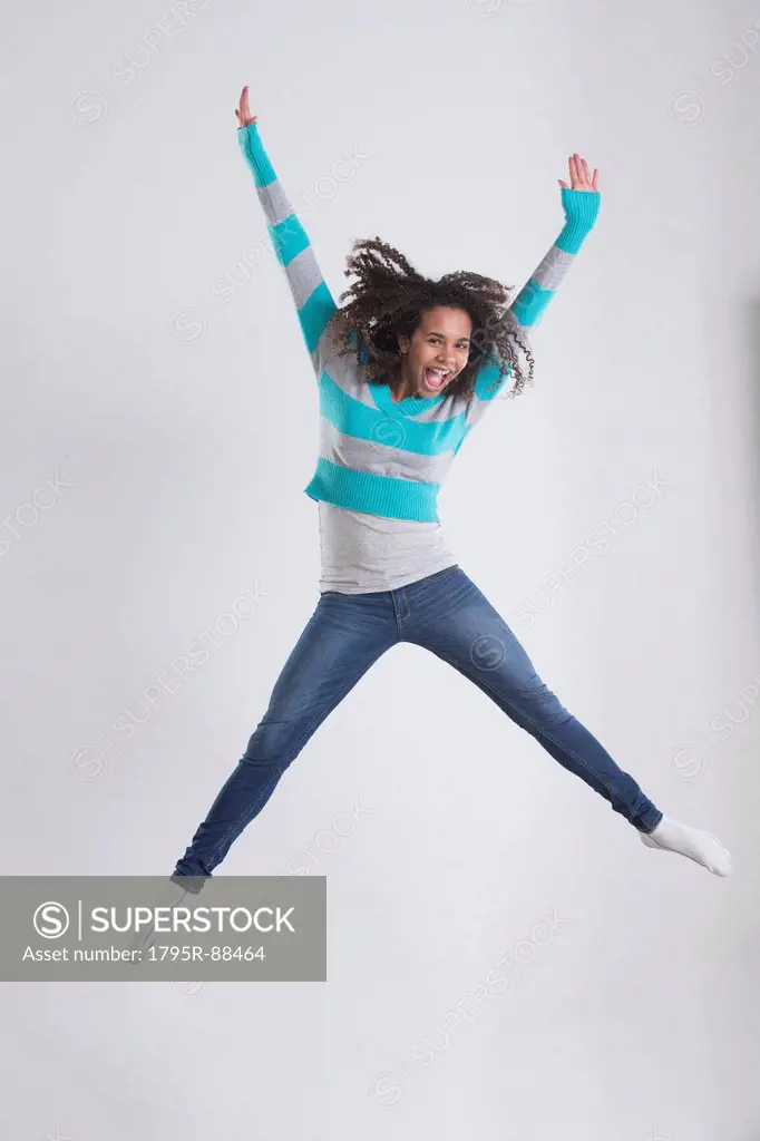 Studio Shot of girl (12-13) jumping