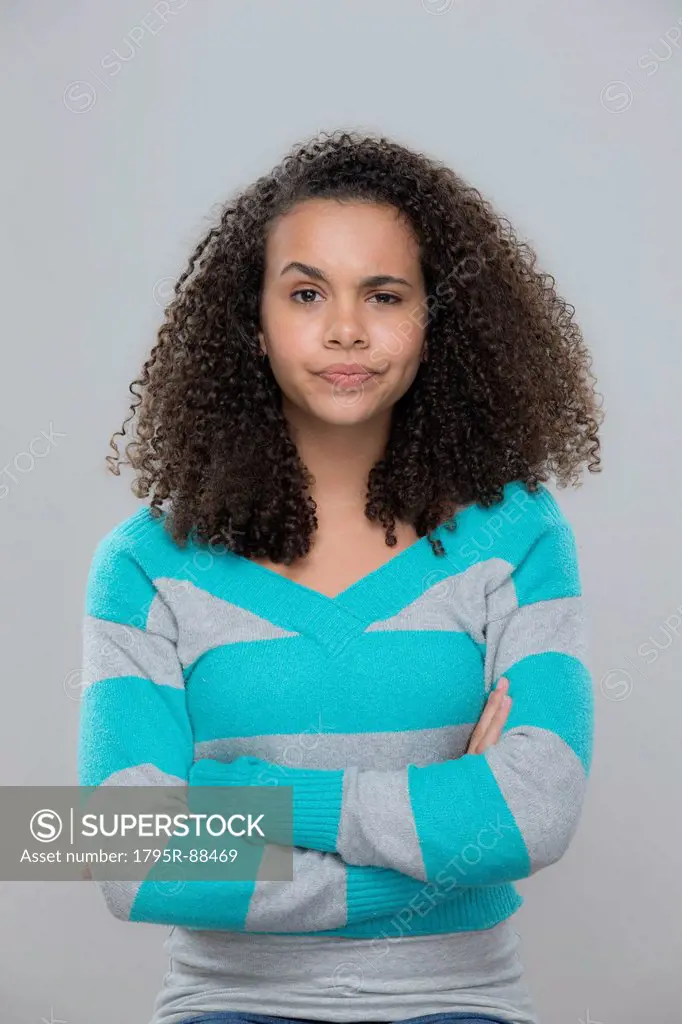 Portrait of girl (12-13) with arms crossed