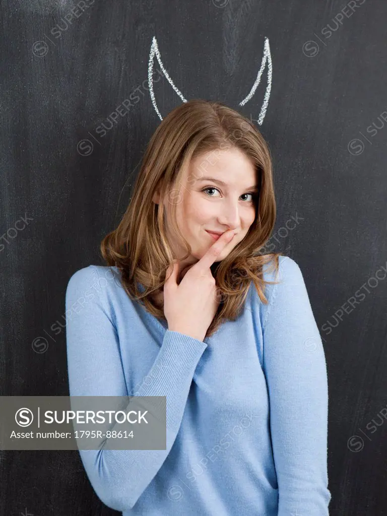 Studio portrait of woman with chalk horns