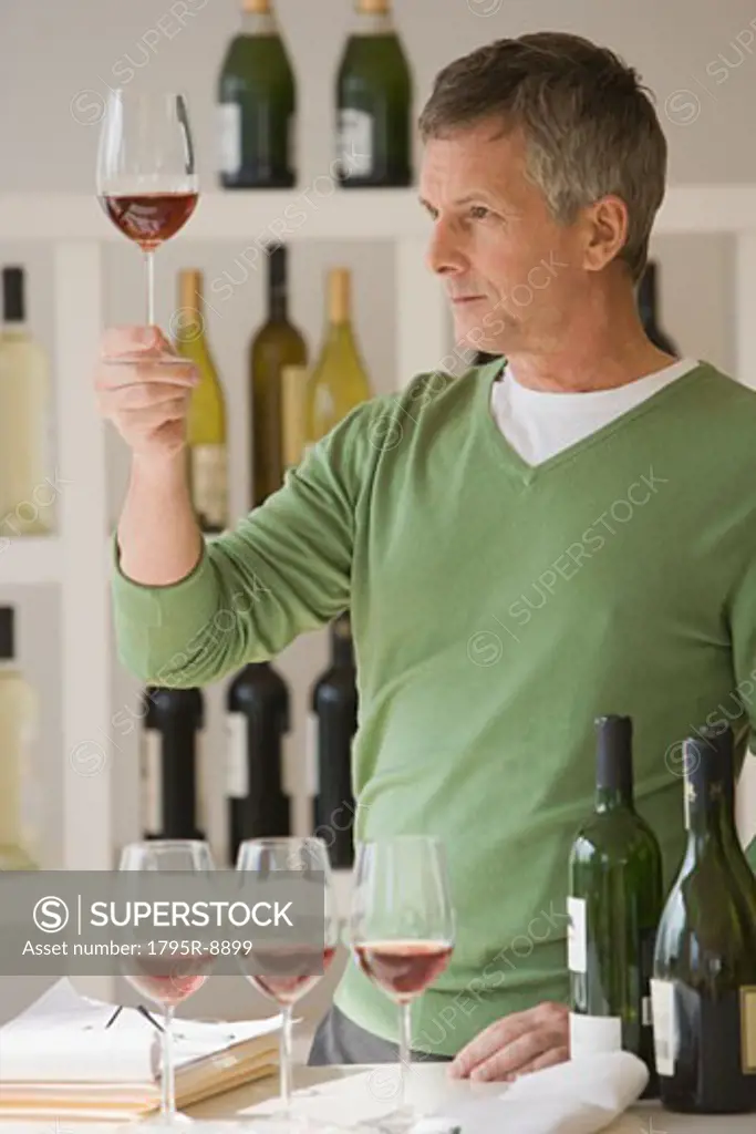 Man looking at glass of wine