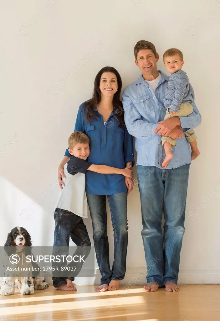 Portrait of parents with two sons (12-17 months, 6-7) and dog