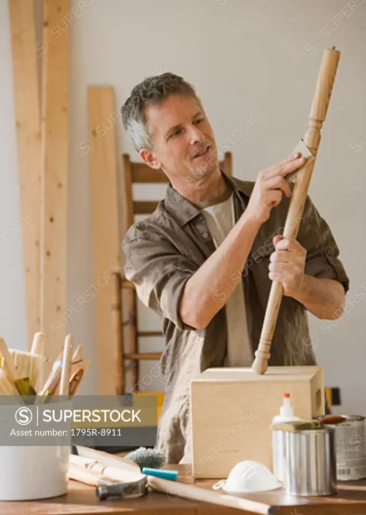 Man sanding piece of wood