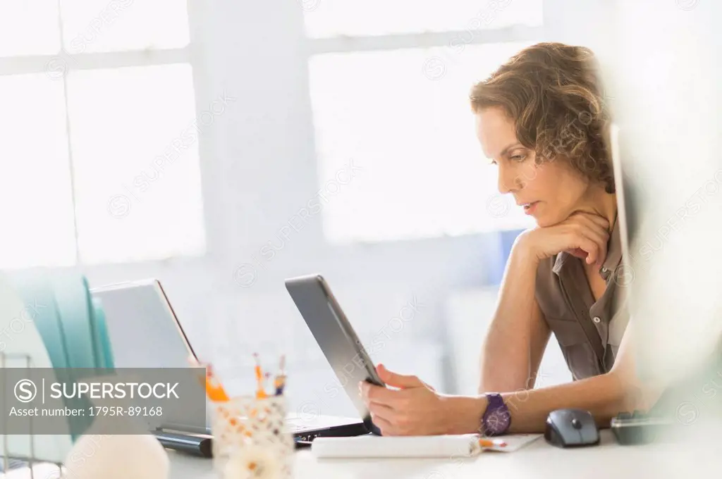 Business woman using digital tablet and laptop