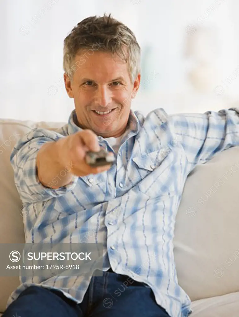 Man pointing television remote control