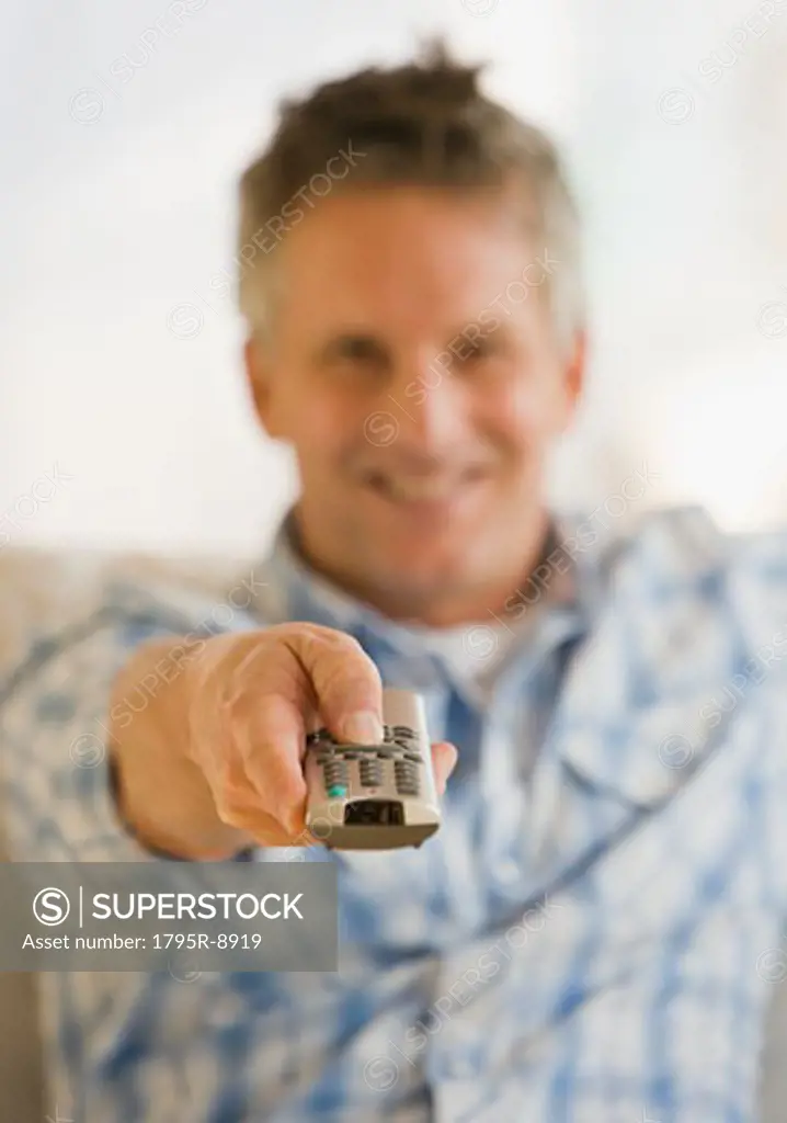 Man pointing television remote control