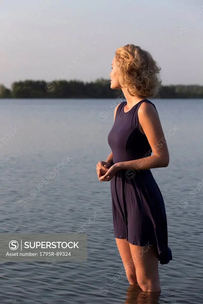 Beautiful woman standing in lake
