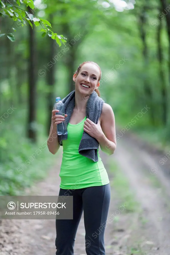 Portrait of woman jogging in forest