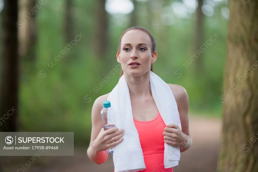 Portrait of woman holding bottle of water