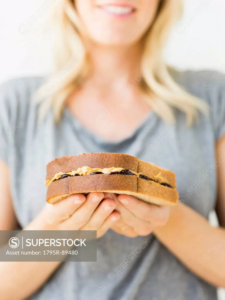 Woman holding sandwich with peanut butter