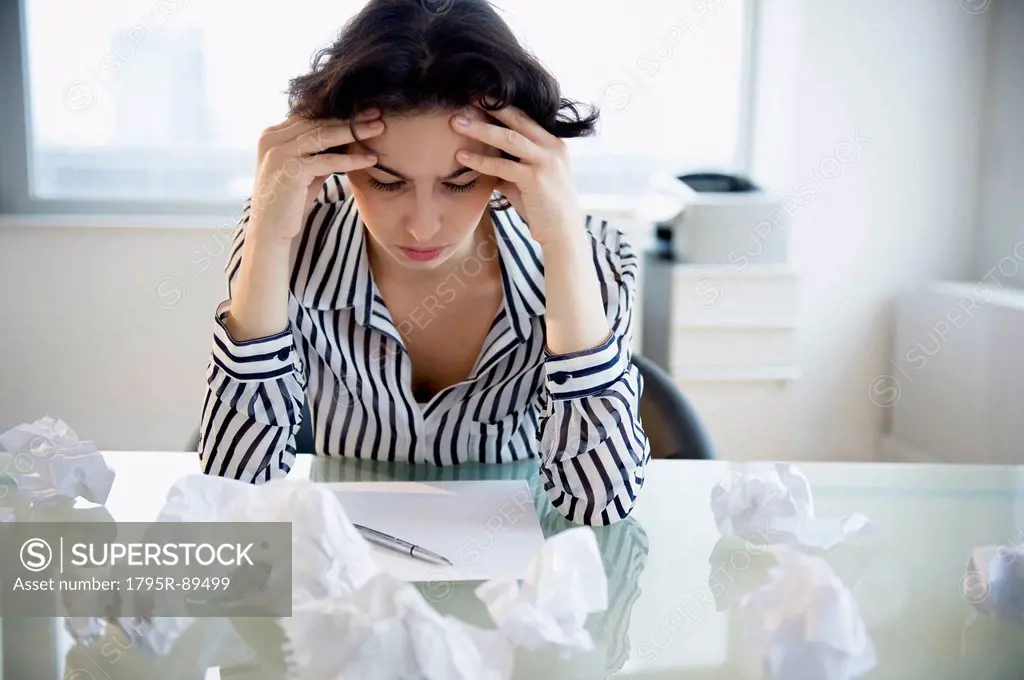 Overworked businesswoman sitting at desk