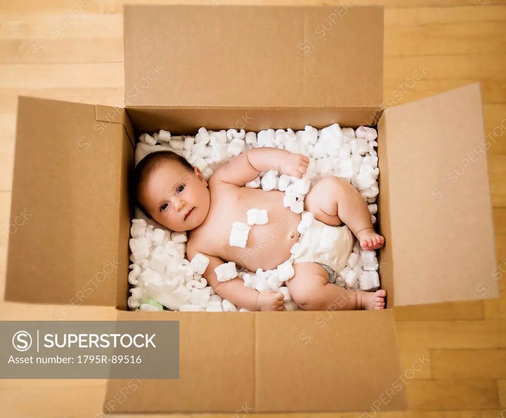 Baby girl (2-5 months) in cardboard box