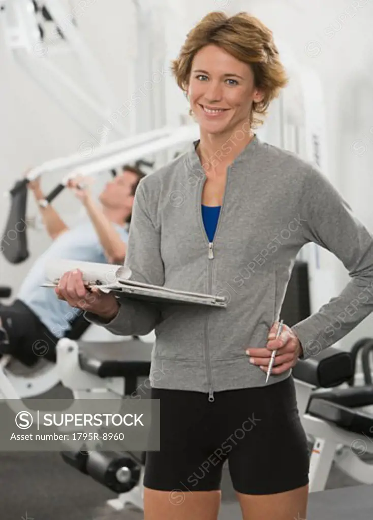 Female person trainer holding chart
