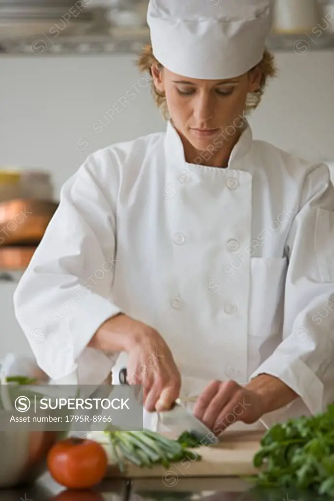 Female chef chopping vegetables