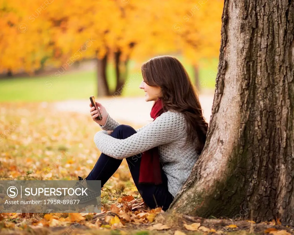 Young woman using cell phone in Central Park