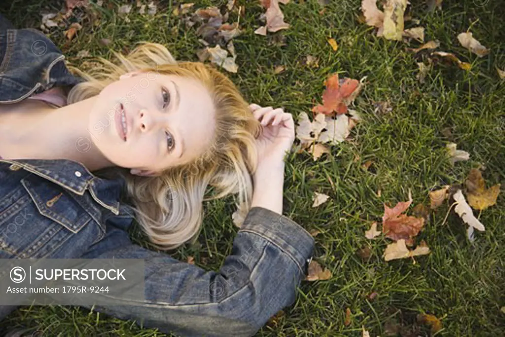 Woman lying in grass on a fall day
