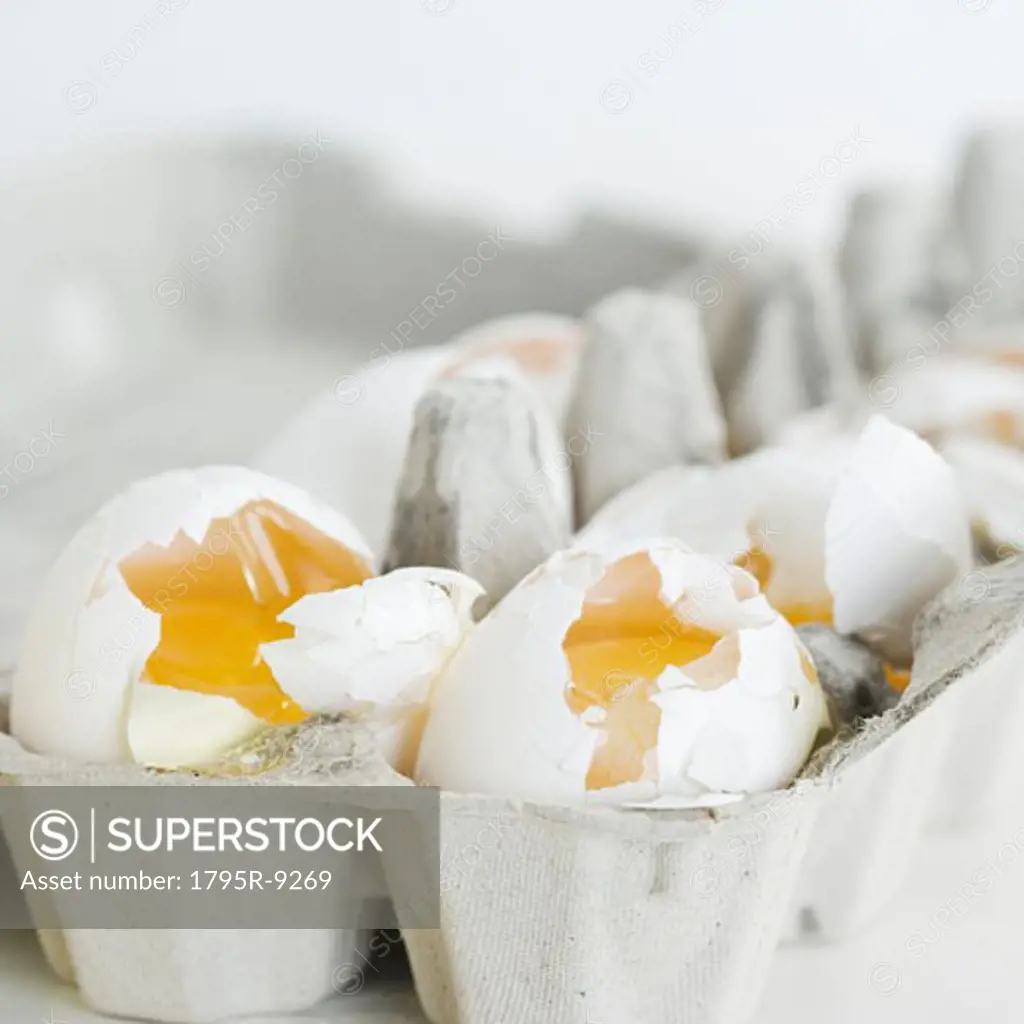 Close-up of broken eggs in carton