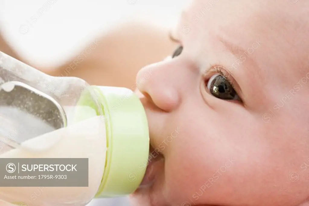 Close-up of baby drinking from bottle