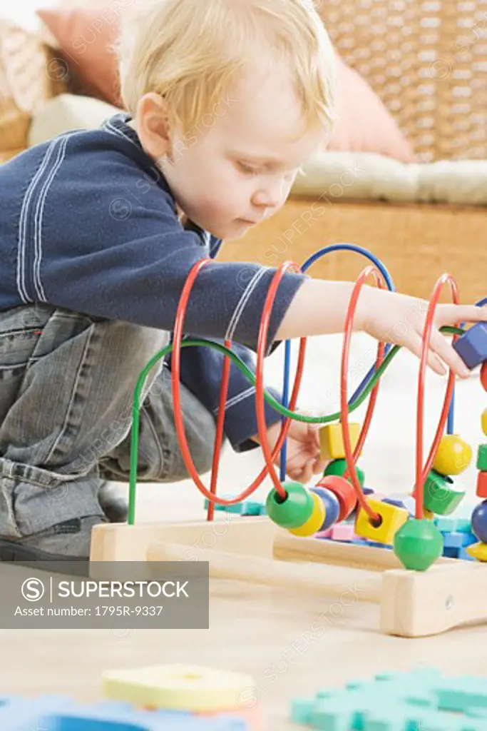 Young boy playing with block toy