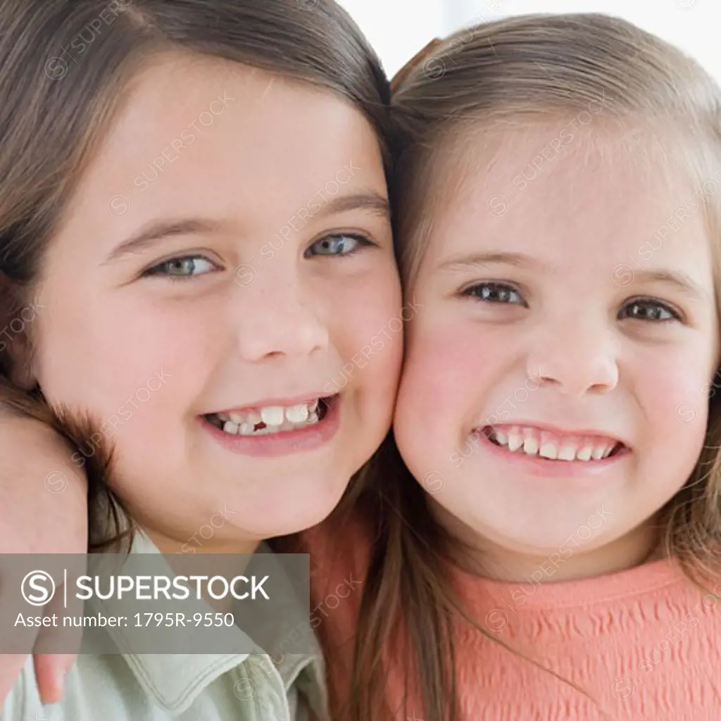 Close-up of sisters smiling