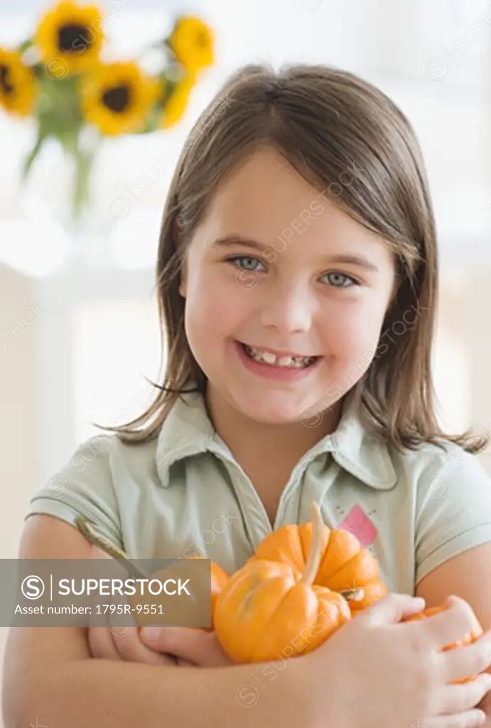 Portrait of girl holding pumpkins