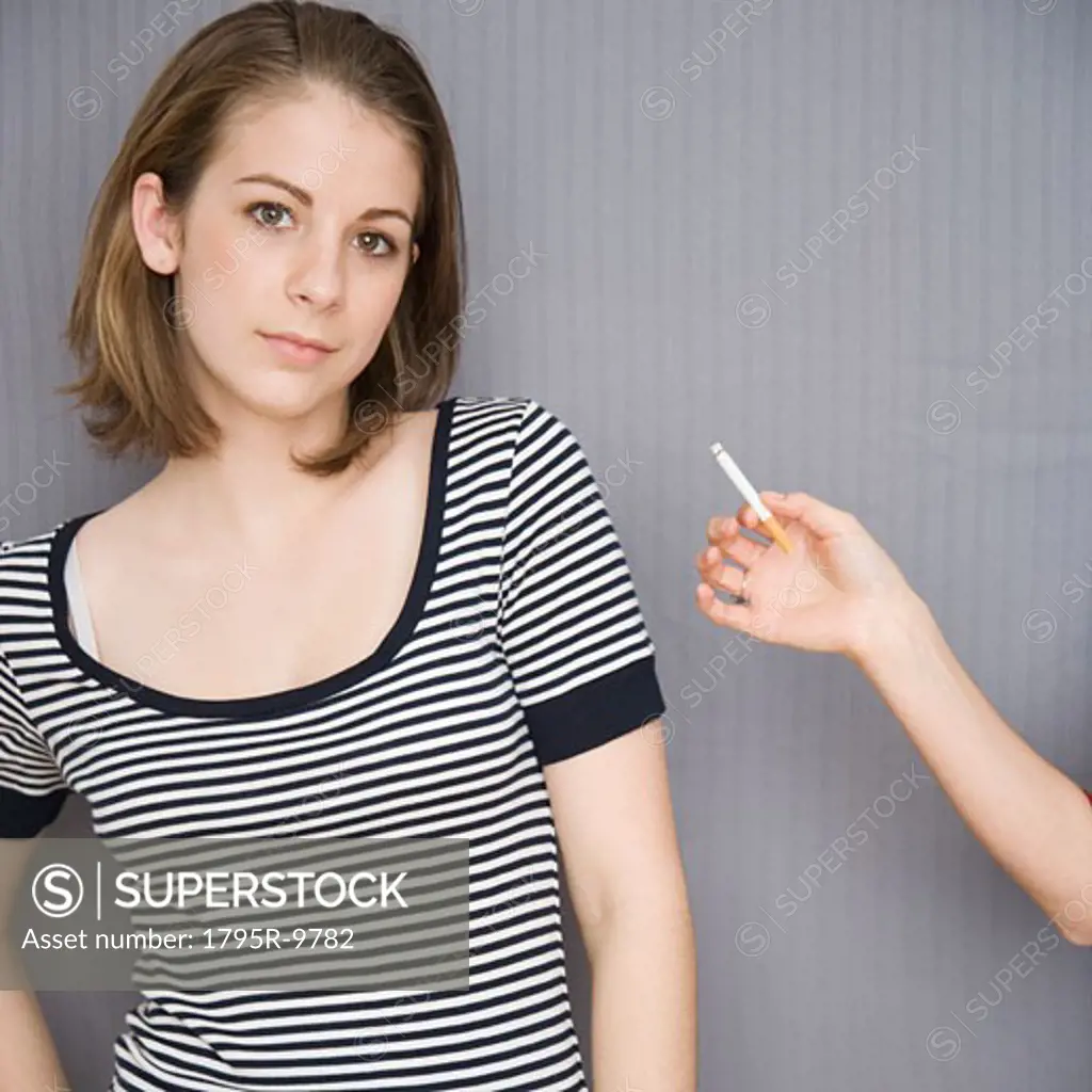 Teenage girl next to friend holding cigarette