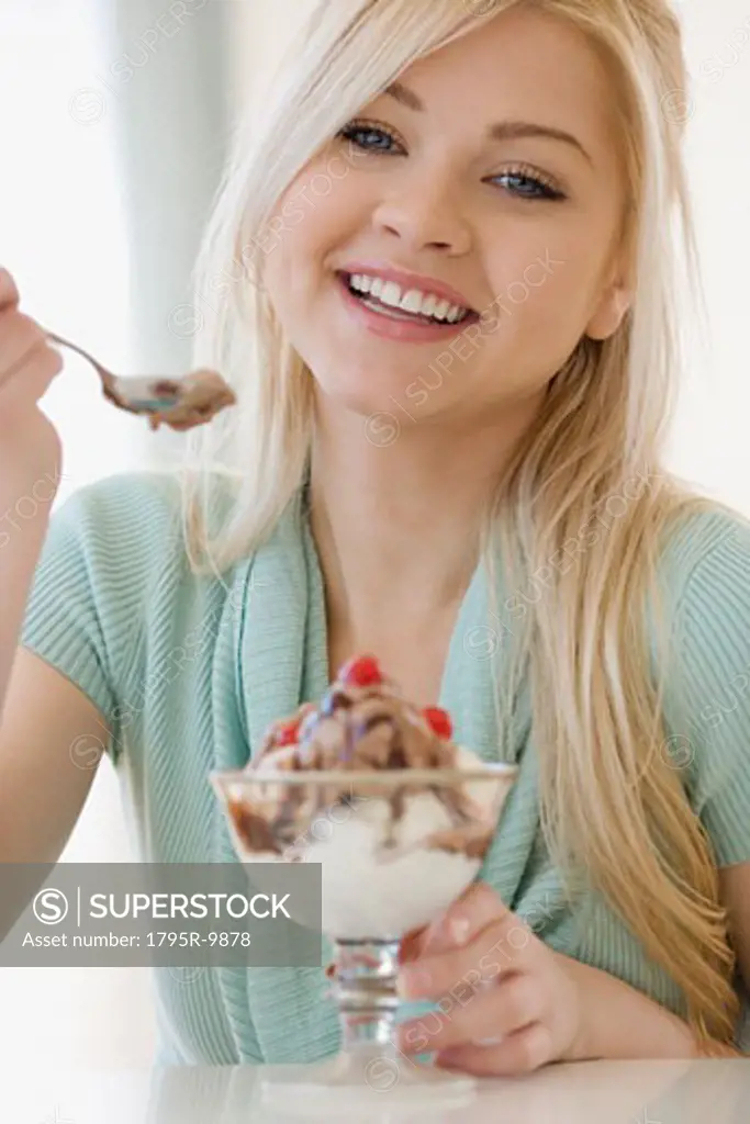 Woman eating ice cream sundae
