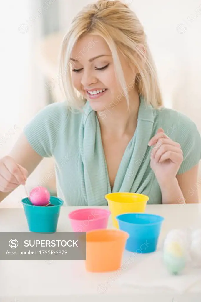 Woman dying Easter eggs