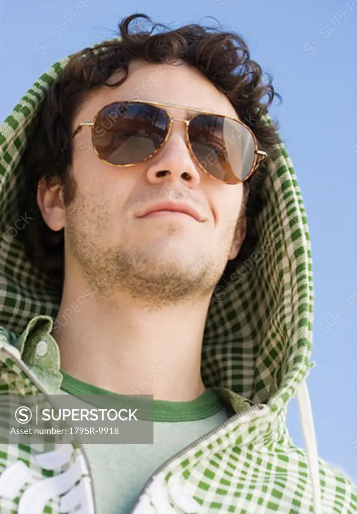 Man wearing hood and sunglasses