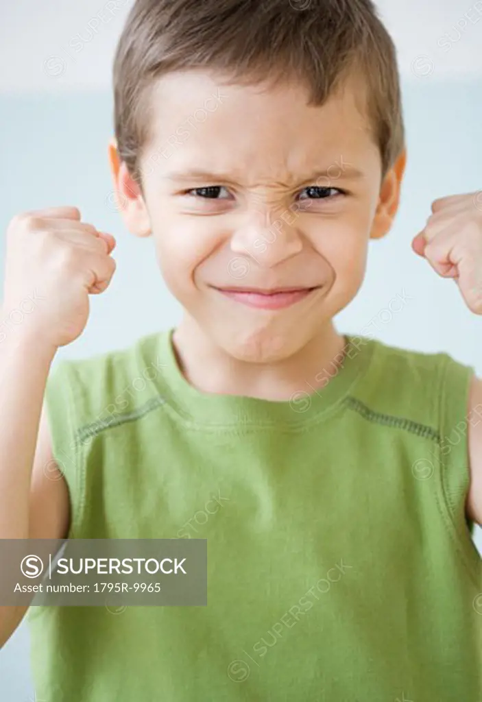 Boy making a face and clenching fists