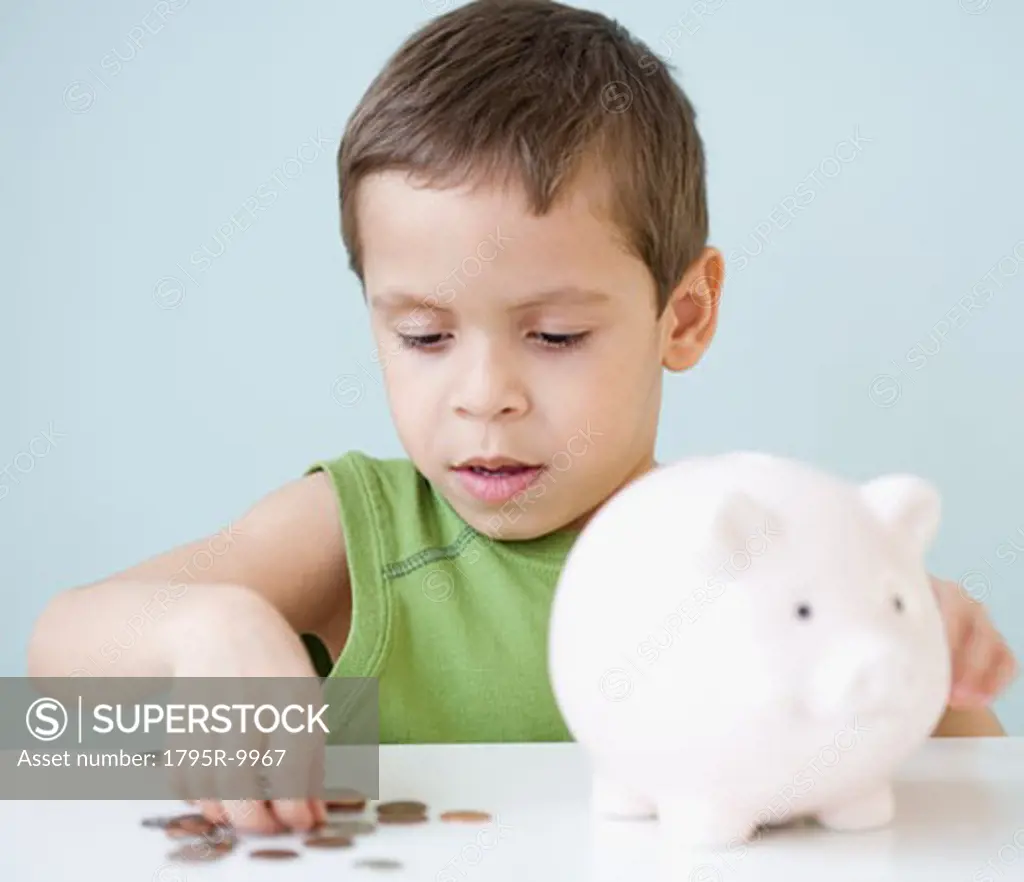 Boy counting coins from piggy bank
